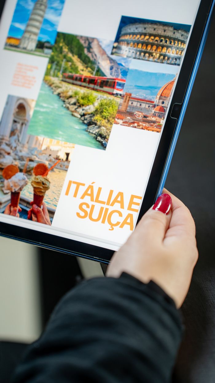 Services Person browsing Italy and Switzerland travel photos on a tablet.