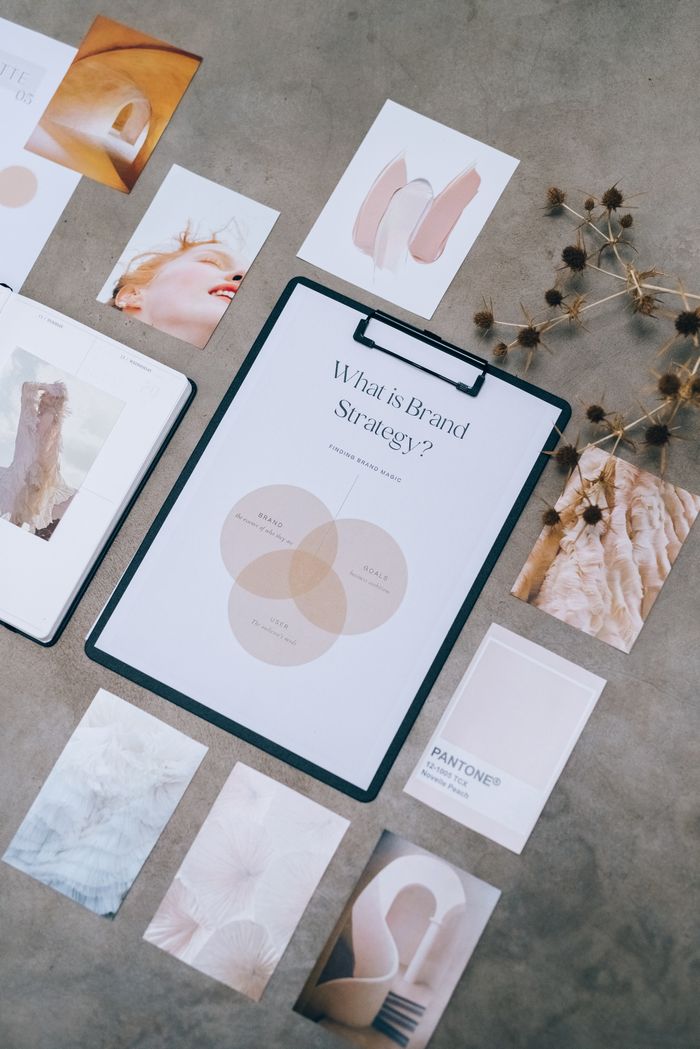 About Aesthetic flat lay of branding and design documents on textured surface.